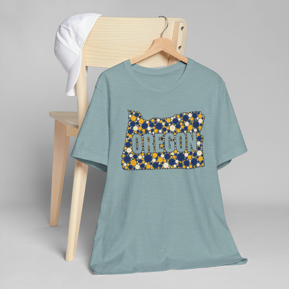 Light blue crewneck t-shirt with Oregon graphic in blue and gold dots