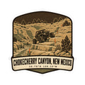 Die-cut sticker with off-road vehicle over desert canyon rocks and 'Chokecherry Canyon, New Mexico' text
