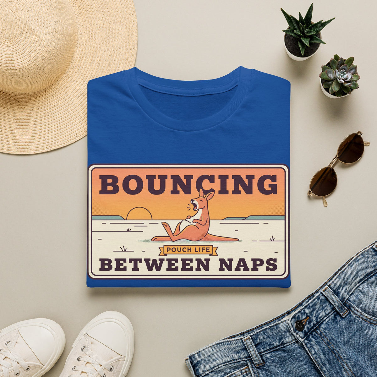 Royal blue T-shirt with kangaroo “Bouncing Between Naps” graphic
