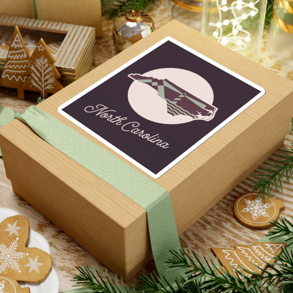 North Carolina decal sticker on gift box lid, purple state silhouette and “North Carolina”