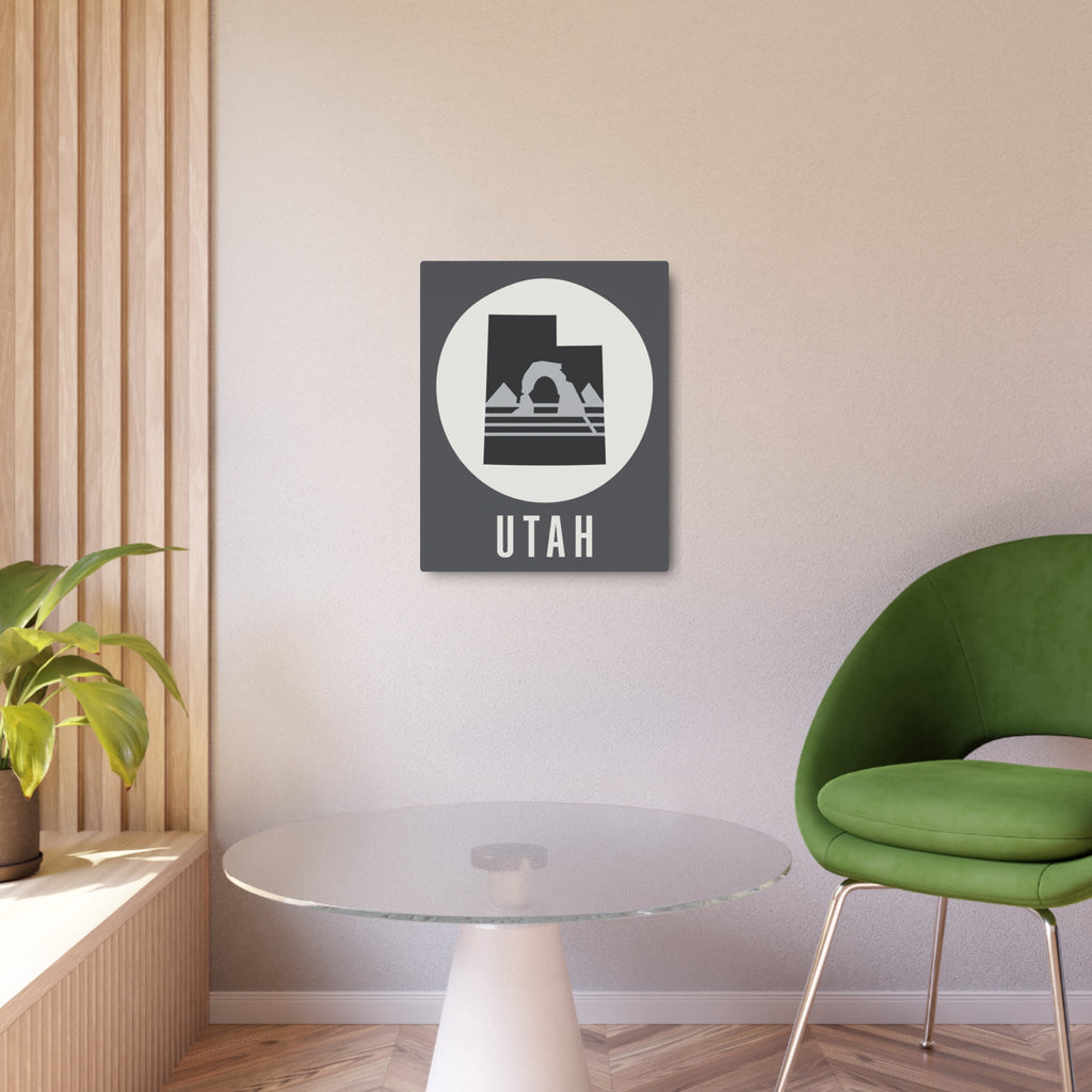 Utah metal wall decor sign on light wall, dark square with white circle and mountain silhouette