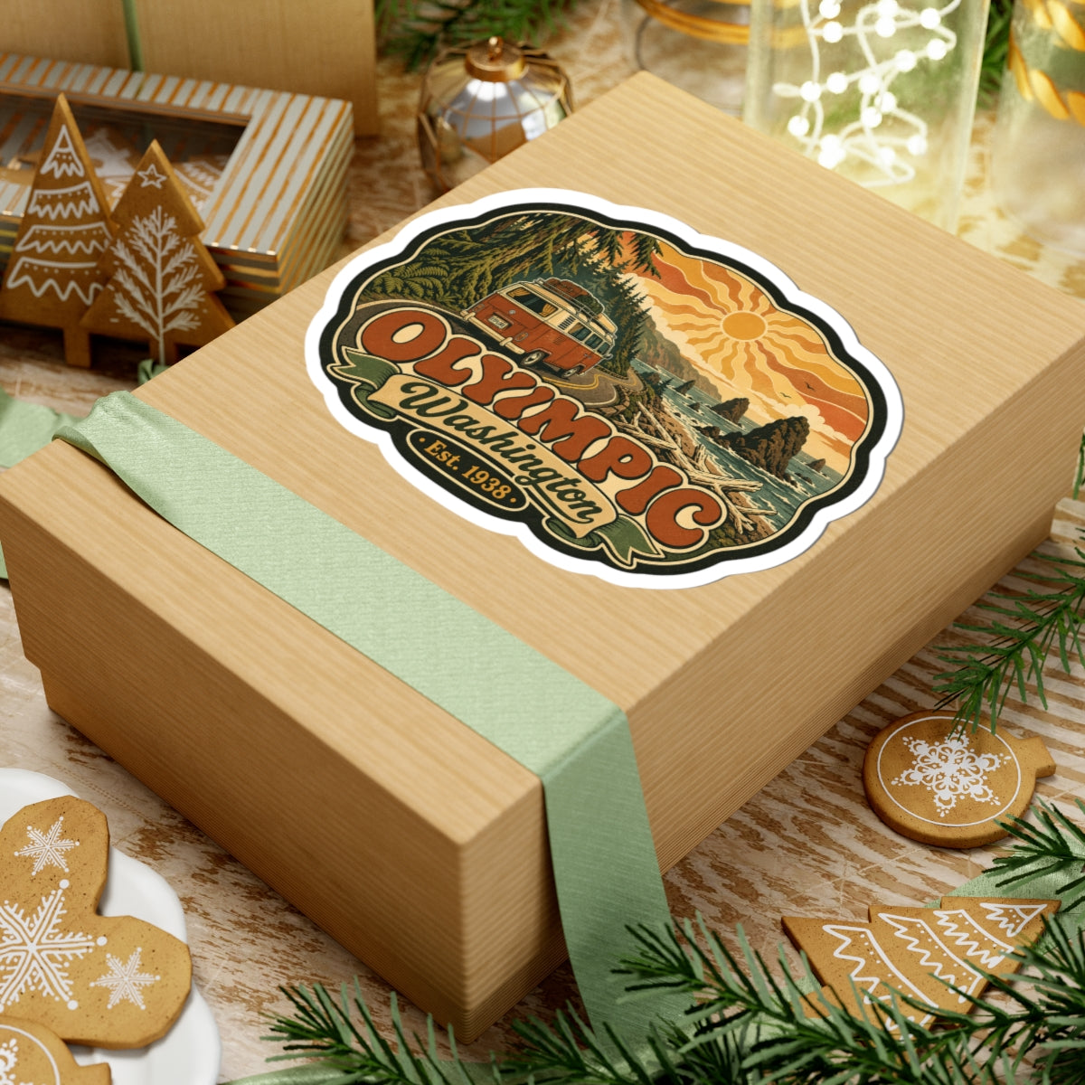 Die-cut sticker with white outline showing vintage camper, pine forest, and “Olympic Washington”, Est. 1938