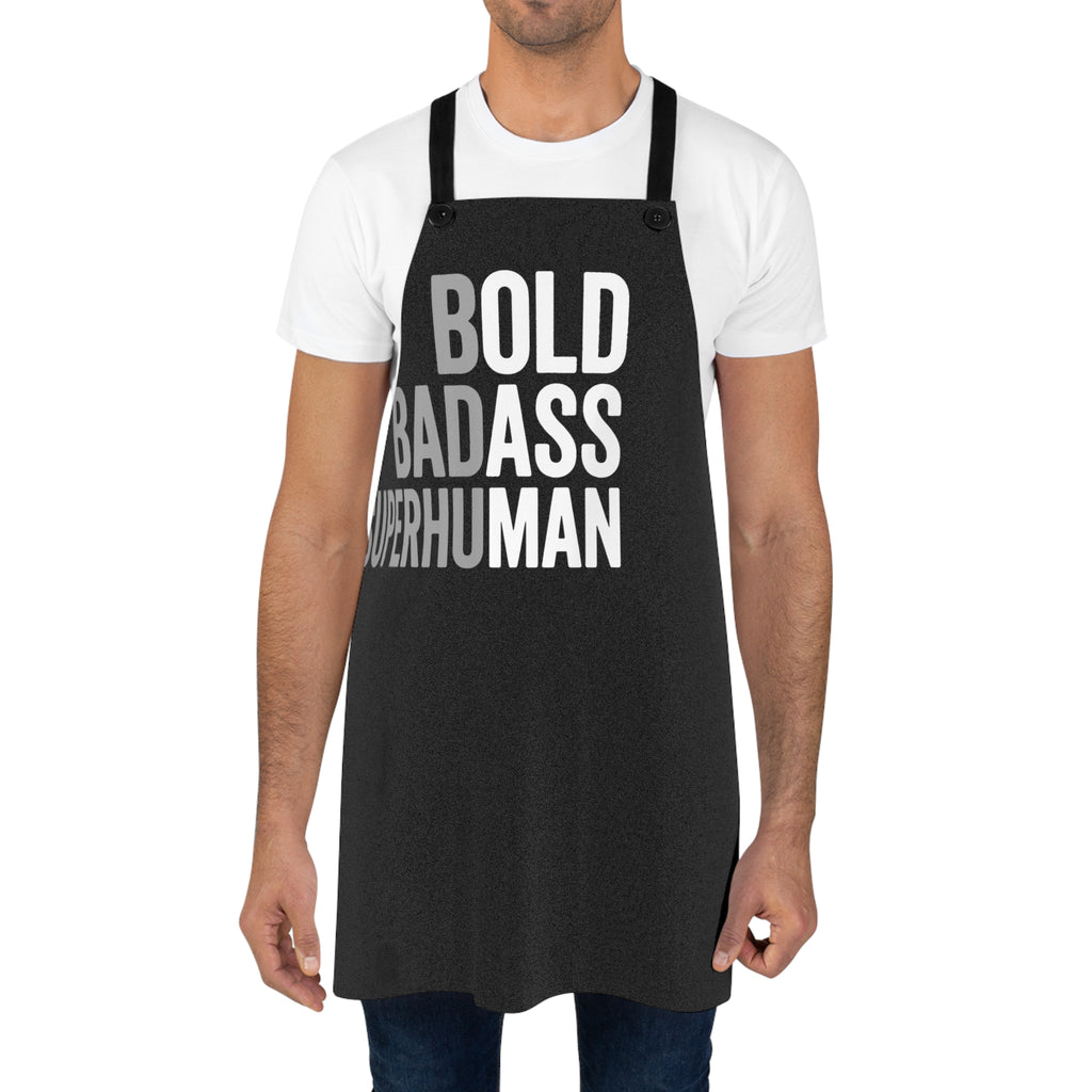Black apron over white T-shirt with bold 'BOLD BADASS SUPERHUMAN' front lettering