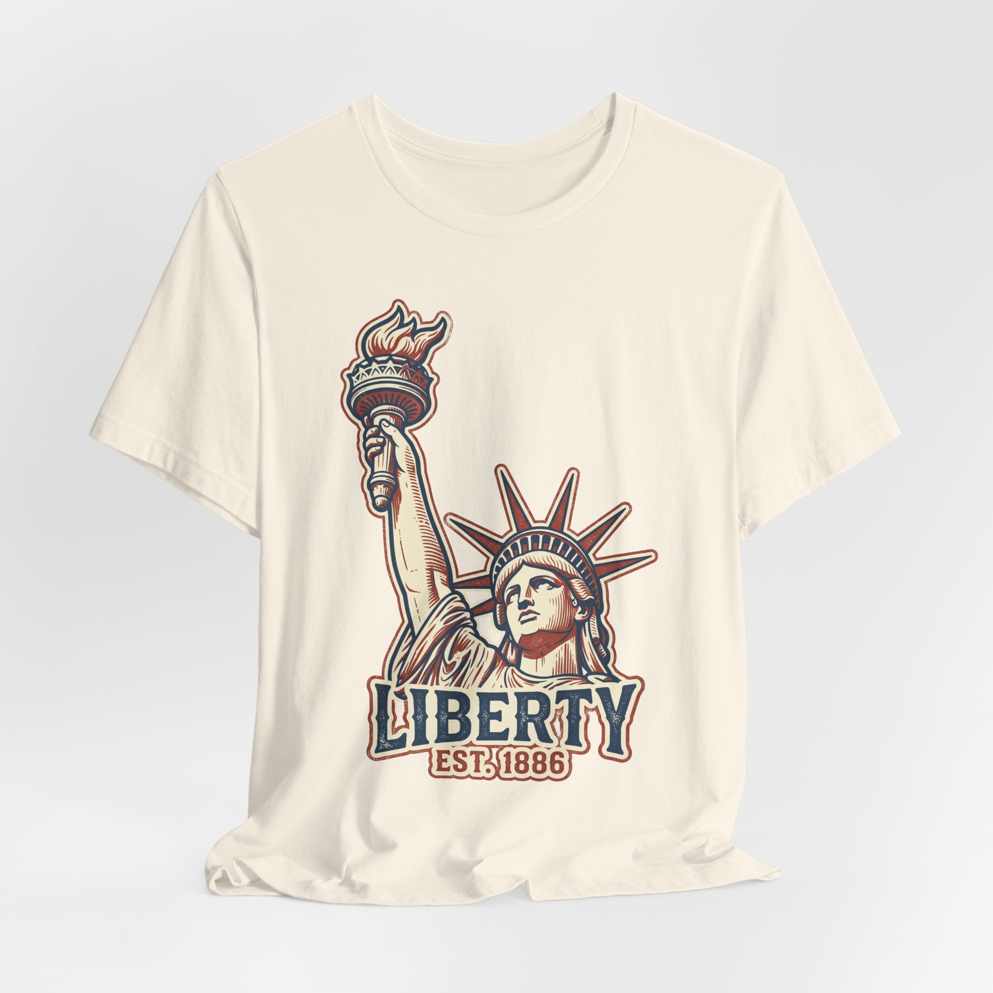 Cream graphic tee with Liberty statue illustration and 'LIBERTY EST.1886' text