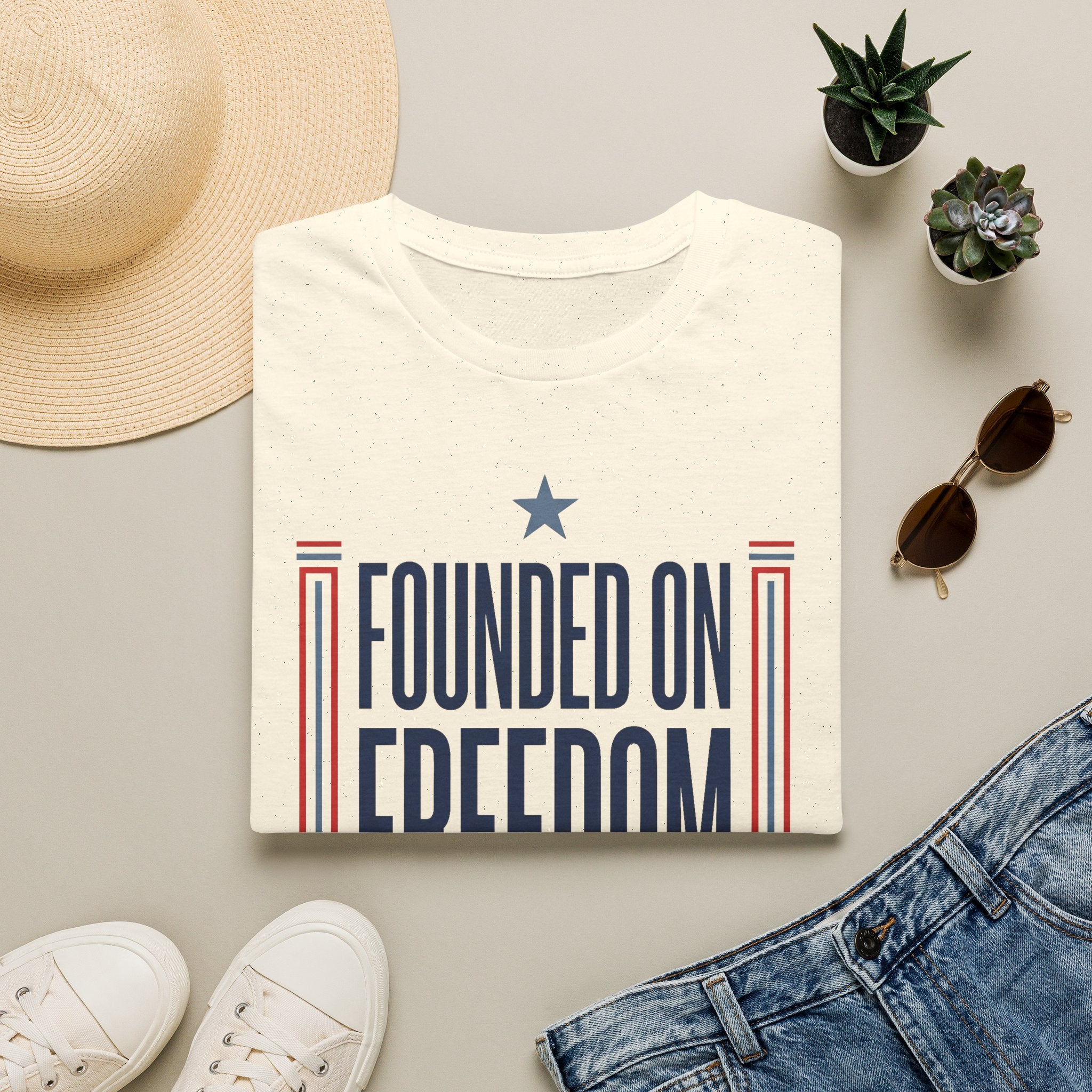 White graphic T-shirt with "Founded on Freedom" text and blue star