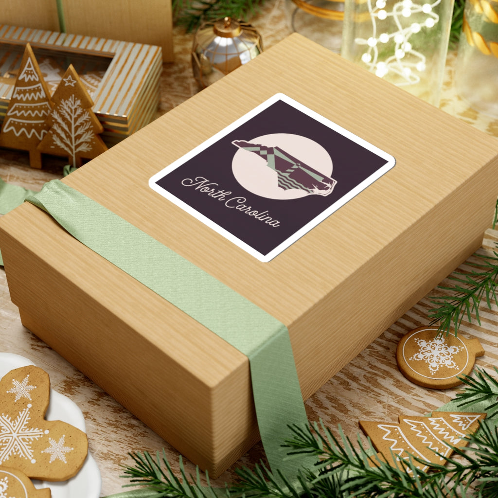 North Carolina decal sticker on wrapped gift, purple state silhouette with “North Carolina”