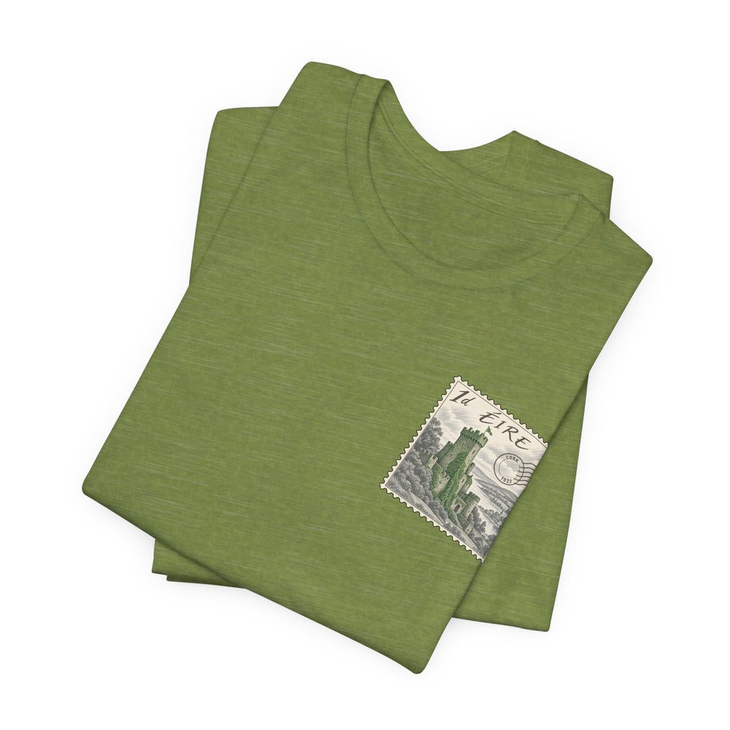 Green heather T-shirt, folded view with small vintage postage stamp graphic on chest.