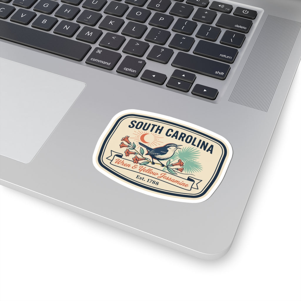 South Carolina sticker on a laptop keyboard: wren and yellow jessamine crest, Est. 1788