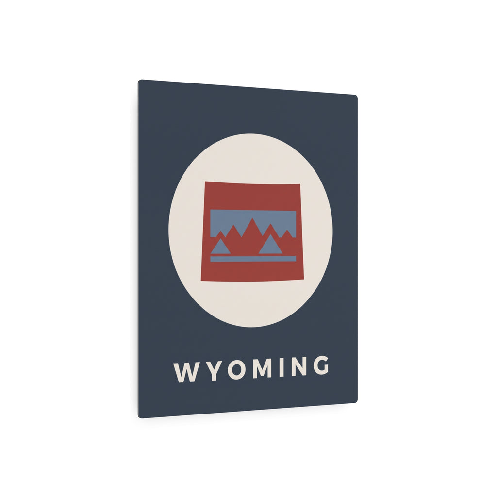 Wyoming state metal art sign, dark blue square with oval mountains graphic and “WYOMING” text.