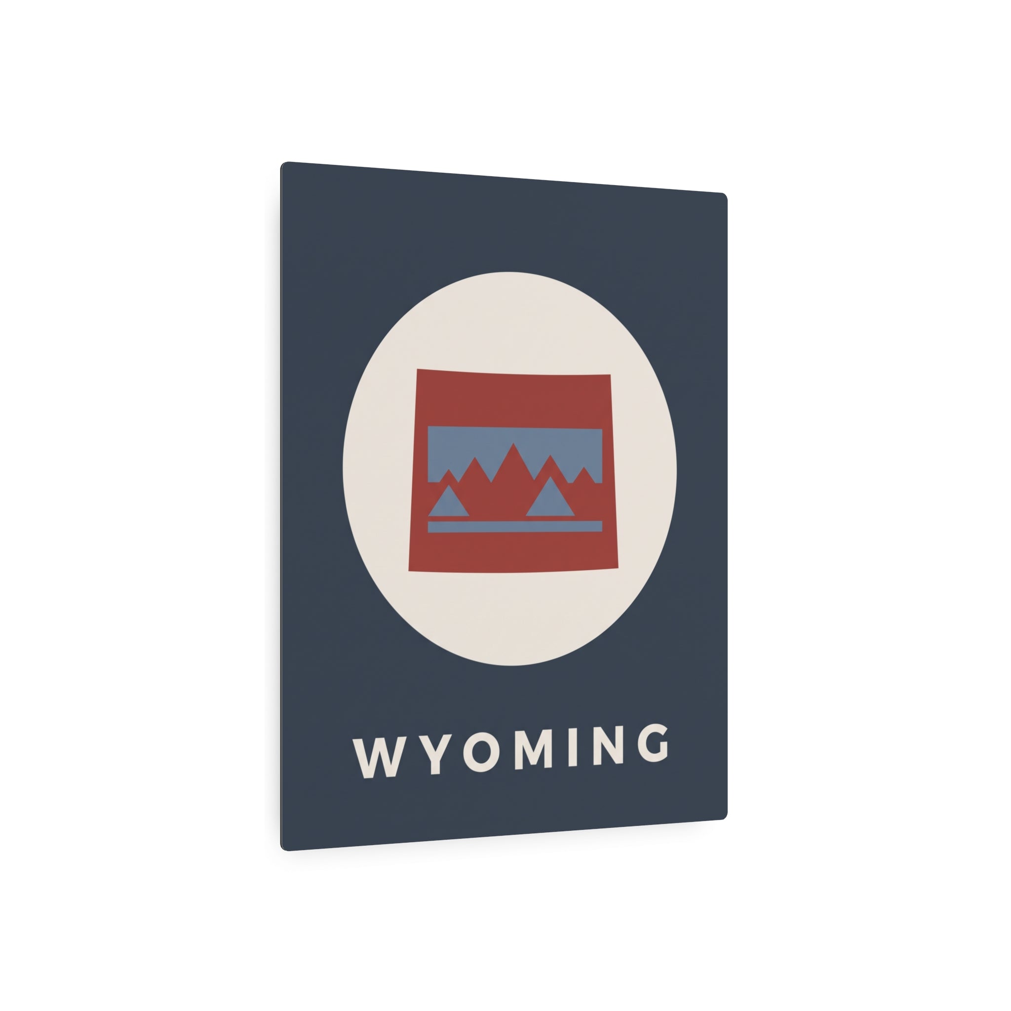 Wyoming state metal art sign, dark blue square with oval mountains graphic and “WYOMING” text.