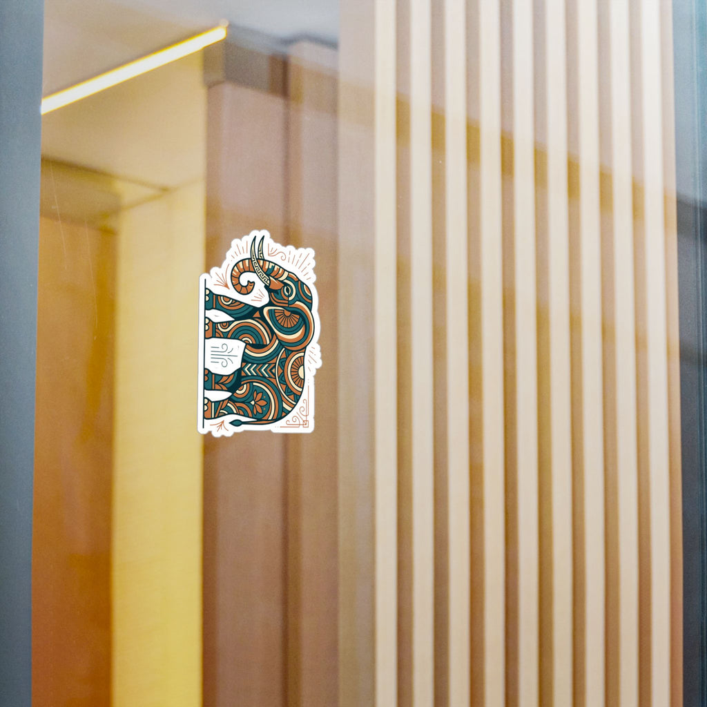 Ornate elephant pattern kiss-cut vinyl decal sticker in teal and orange on a surface