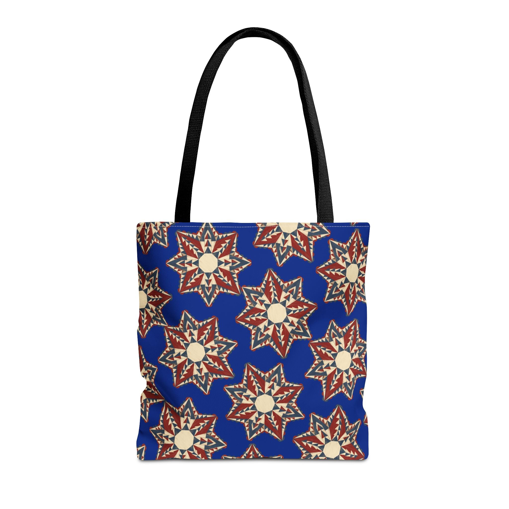 Blue tote bag with starburst floral pattern and black shoulder handles