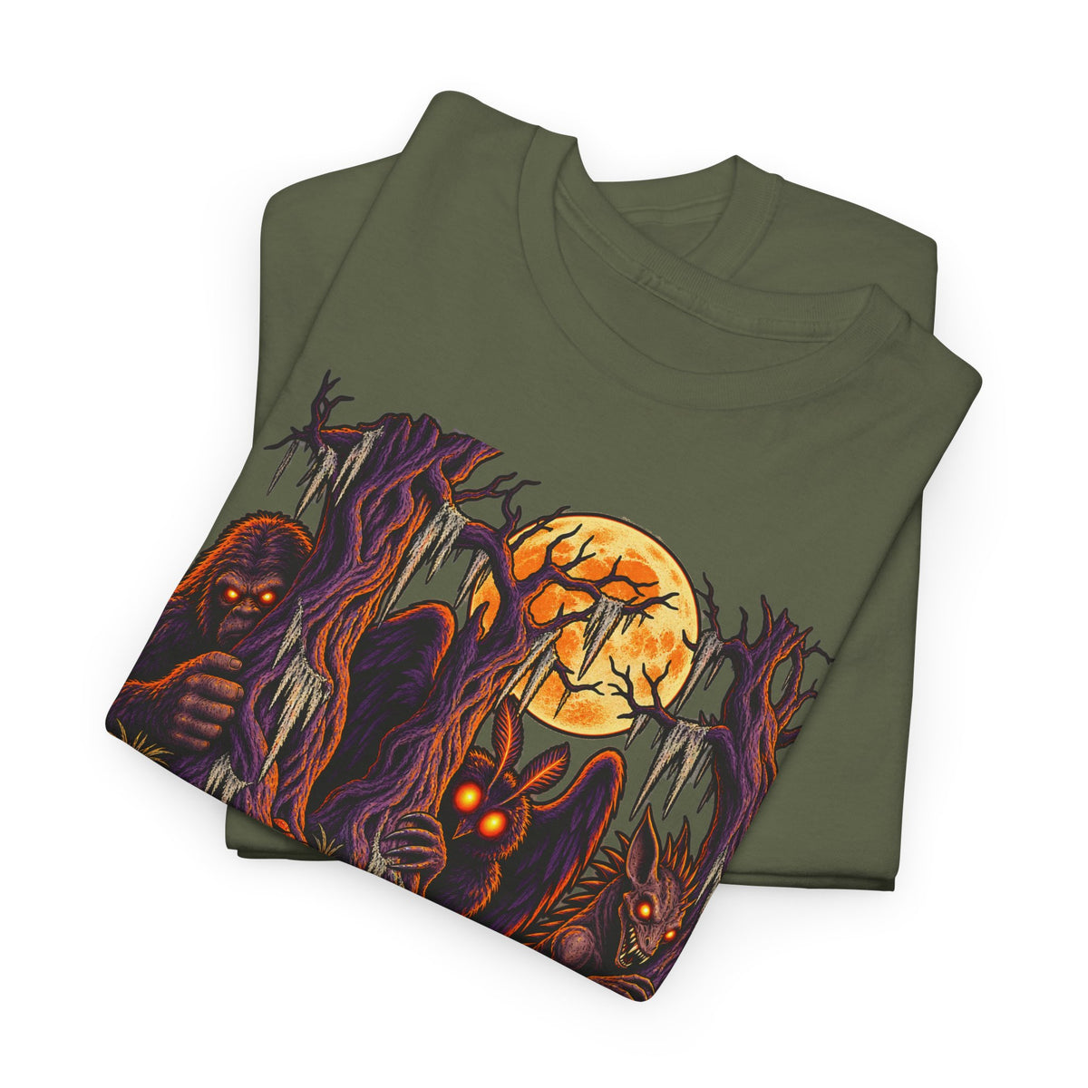 Folded dark olive green tee with colorful haunted forest monster print.