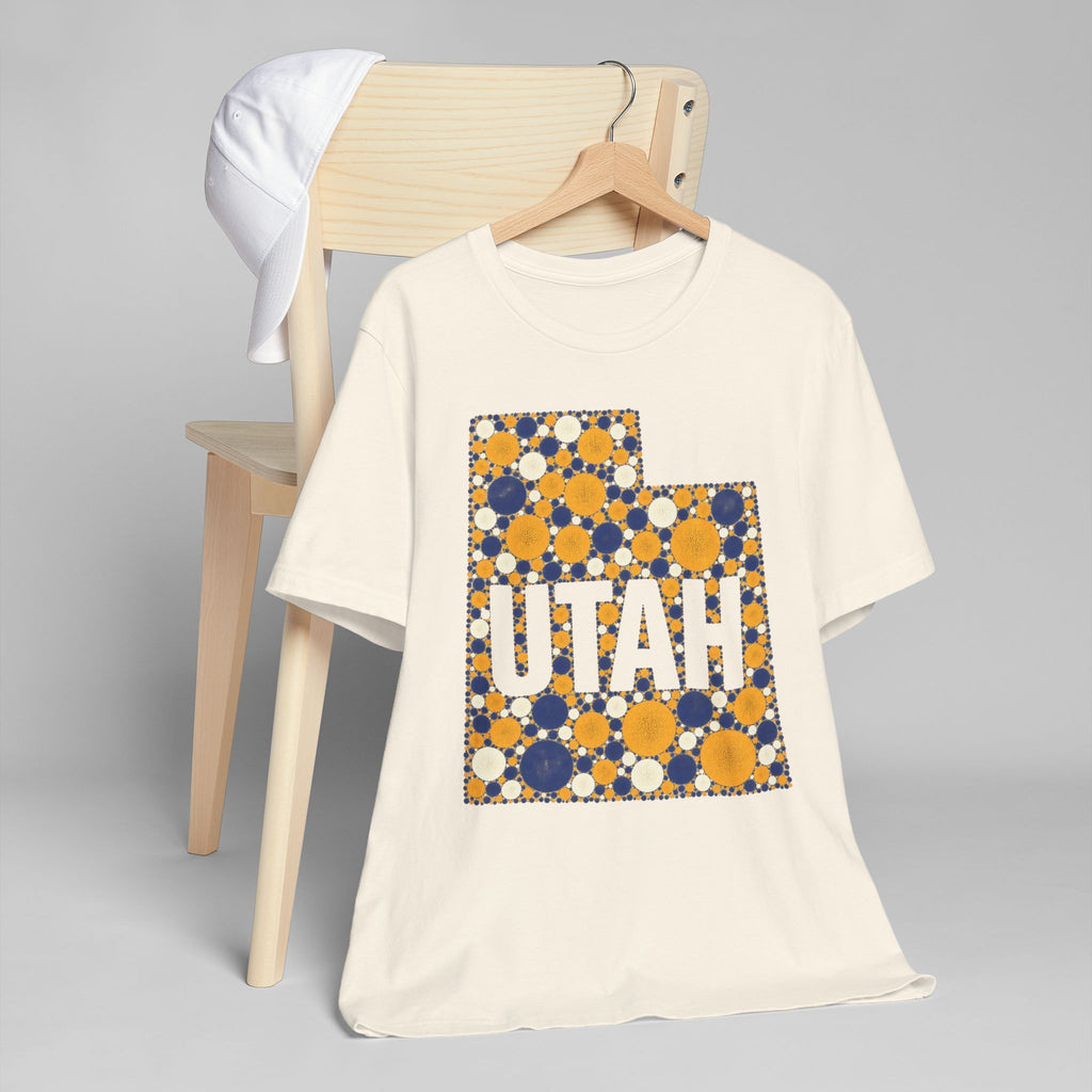 White T-shirt with blue and gold polka-dot Utah map outline and lettering graphic