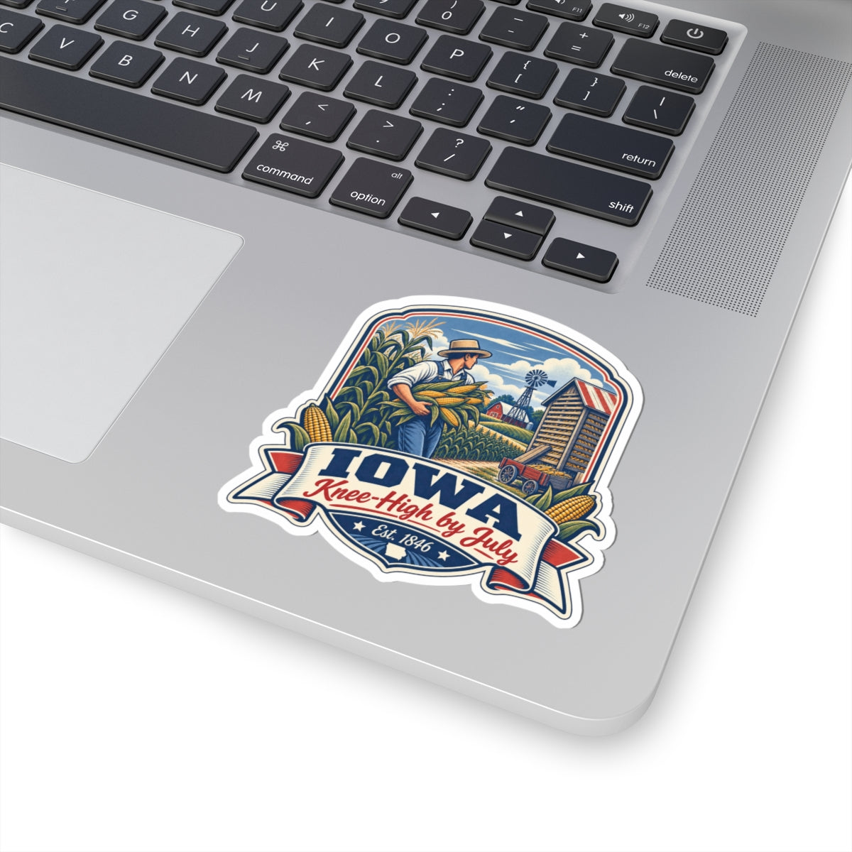 Iowa Knee-High by July sticker decal placed on a laptop top with farmer cornfield artwork