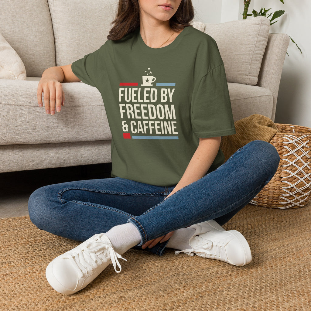Olive green T-shirt worn by model with “Fuelled by Freedom & Caffeine” coffee graphic