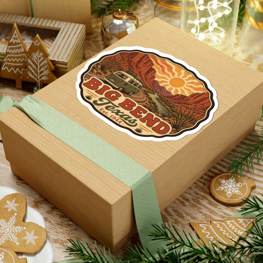 Die-cut road trip sticker on a gift box showing Big Bend Texas lettering, sun, and vintage camper