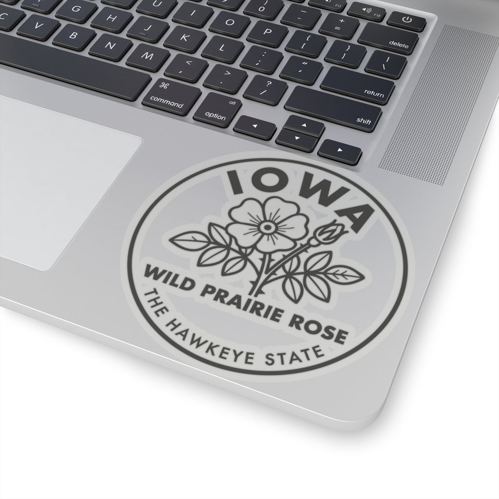 Circular vinyl decal on laptop lid with Iowa lettering and wild prairie rose text