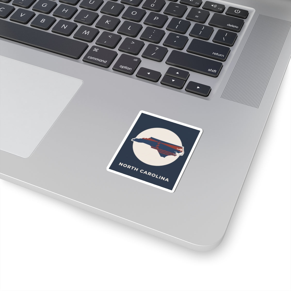 North Carolina state map kiss-cut sticker, blue border with ship graphic