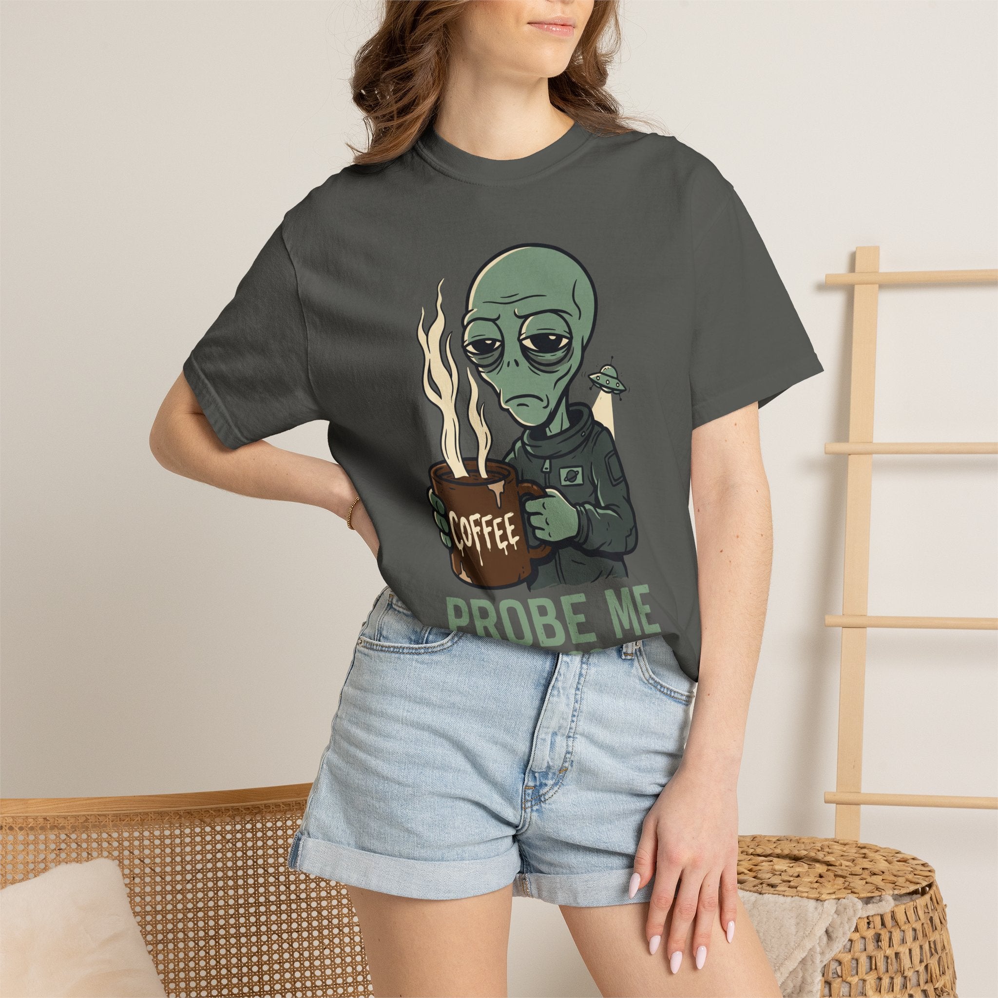 Dark gray T-shirt worn by a model, featuring green alien holding a coffee mug graphic
