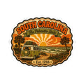 Round South Carolina sticker featuring a vintage camper, palms, sunset sky, Est. 1788.