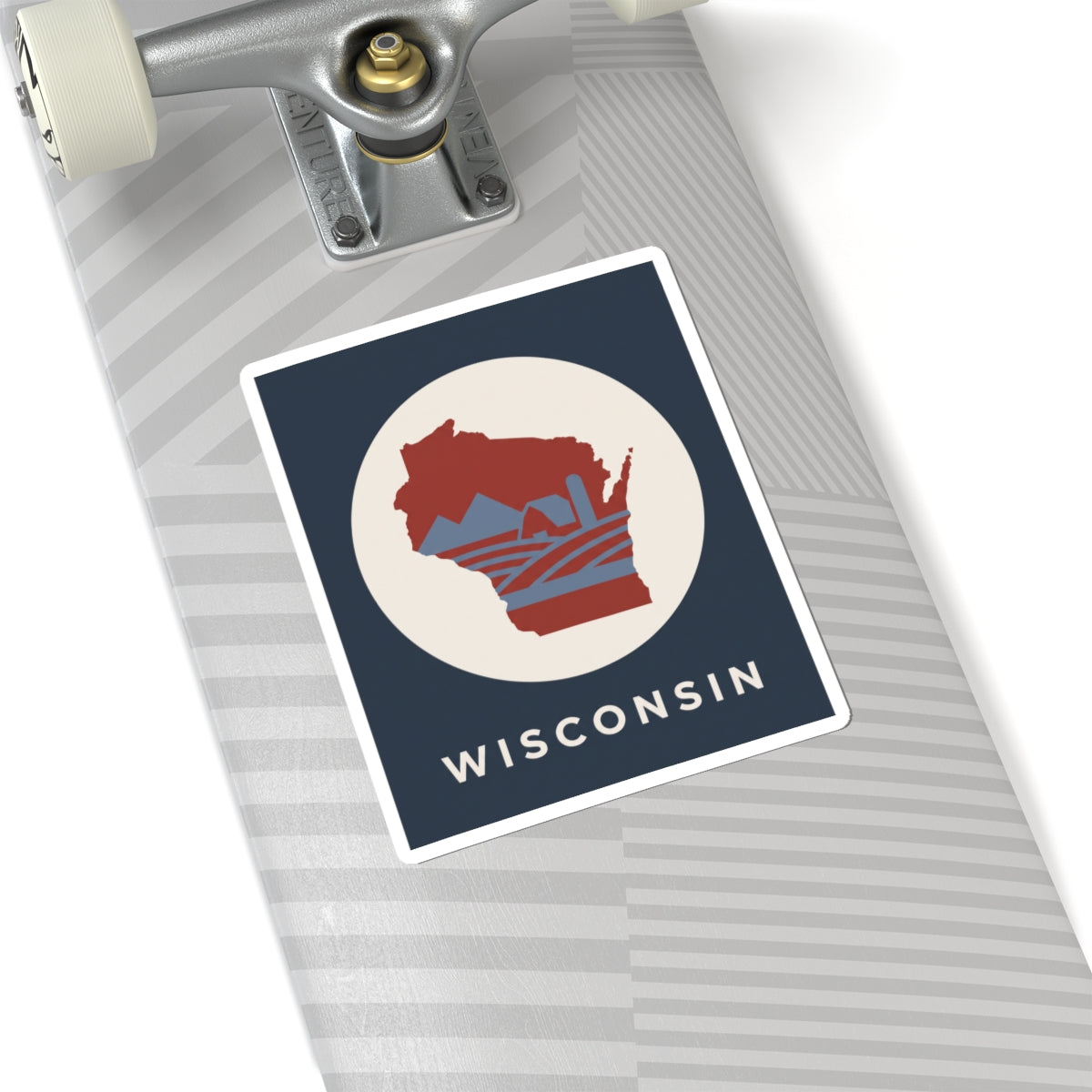Wisconsin badge sticker on notebook: red map in cream circle with WISCONSIN text