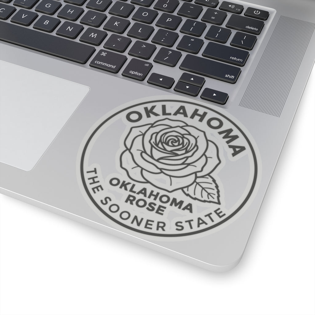 Transparent vinyl Oklahoma rose sticker on laptop lid, round seal showing rose and state text