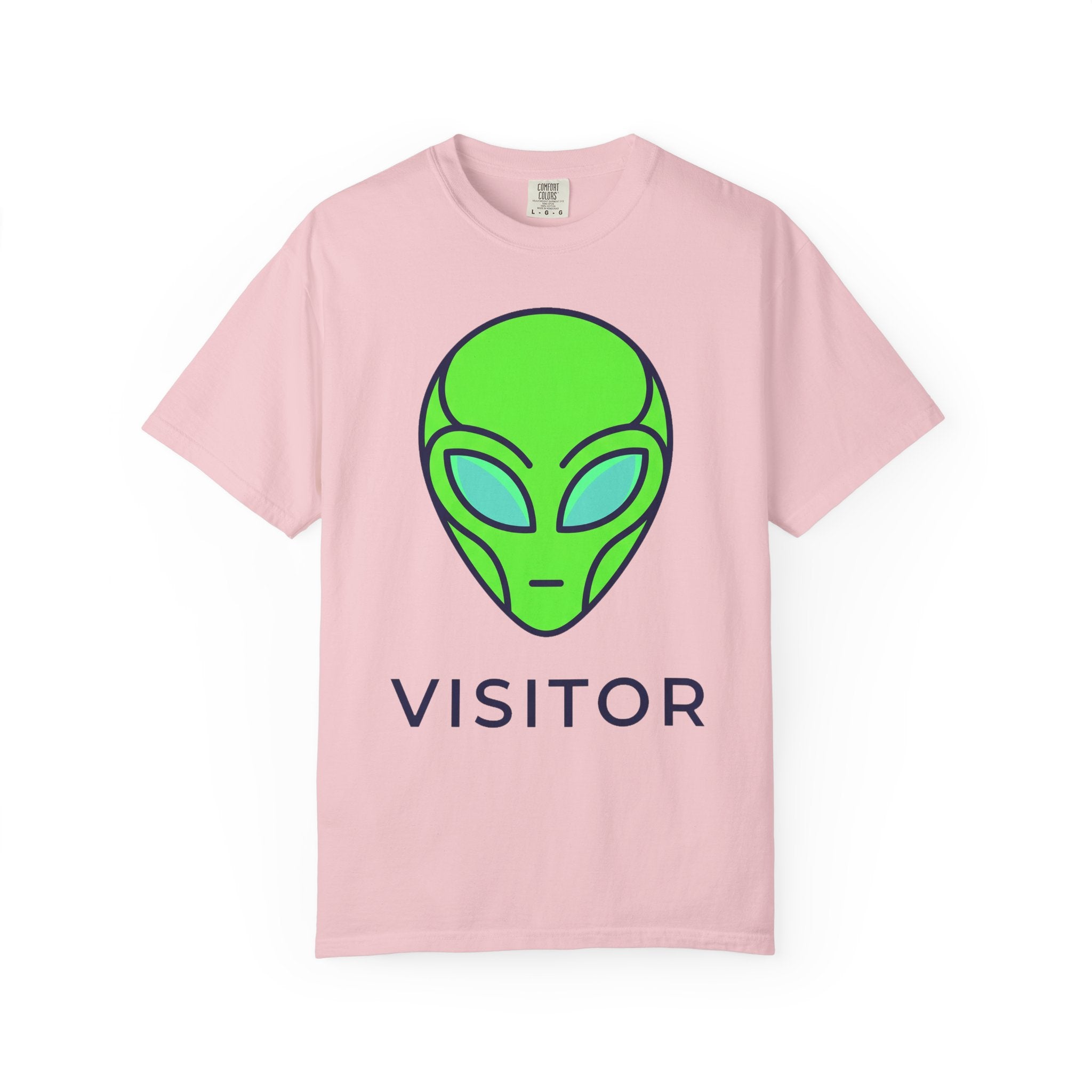 Alien visitor T-shirt in pale pink with neon green alien face and “VISITOR” text