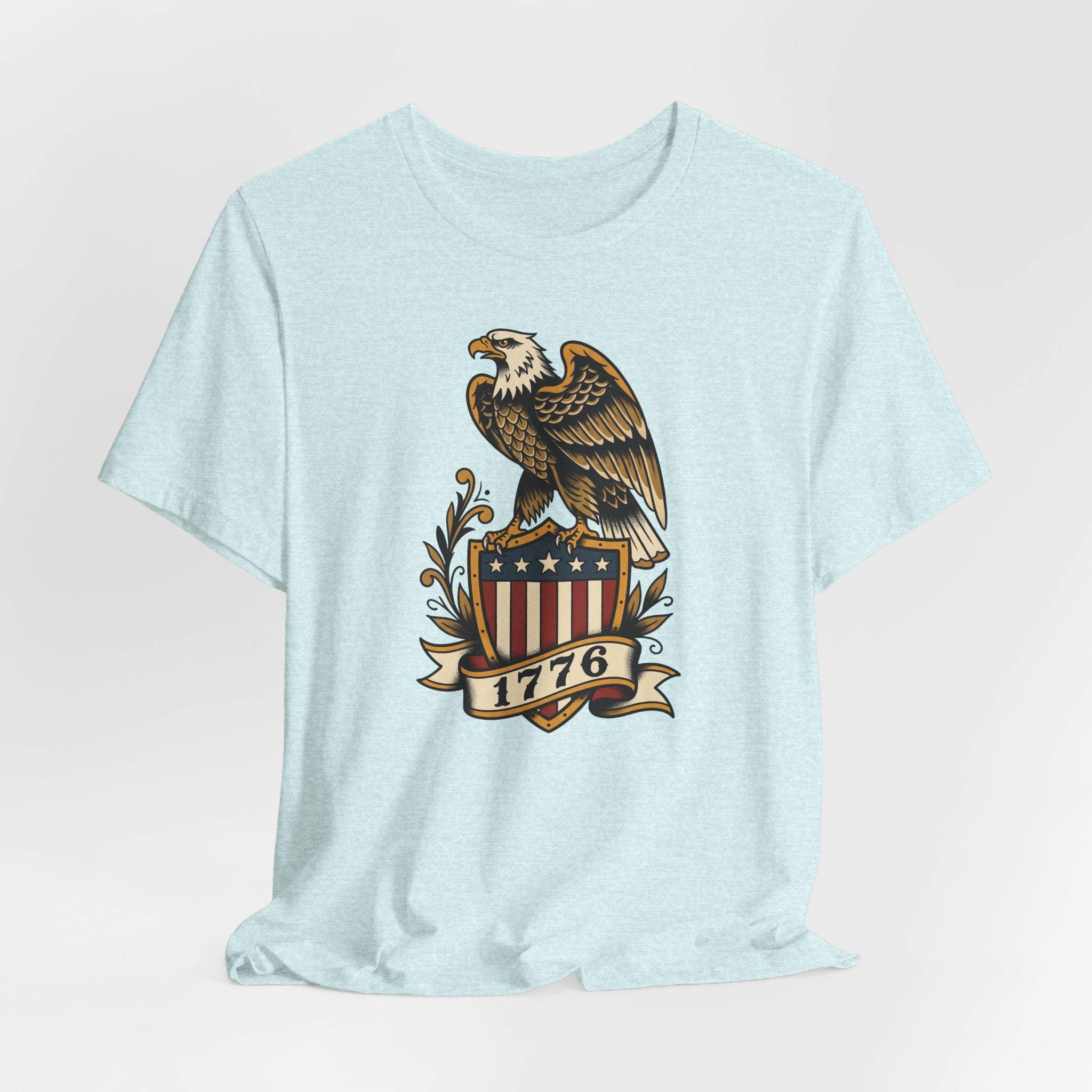 Light blue crewneck T-shirt featuring bald eagle shield graphic with stars and 1776 banner