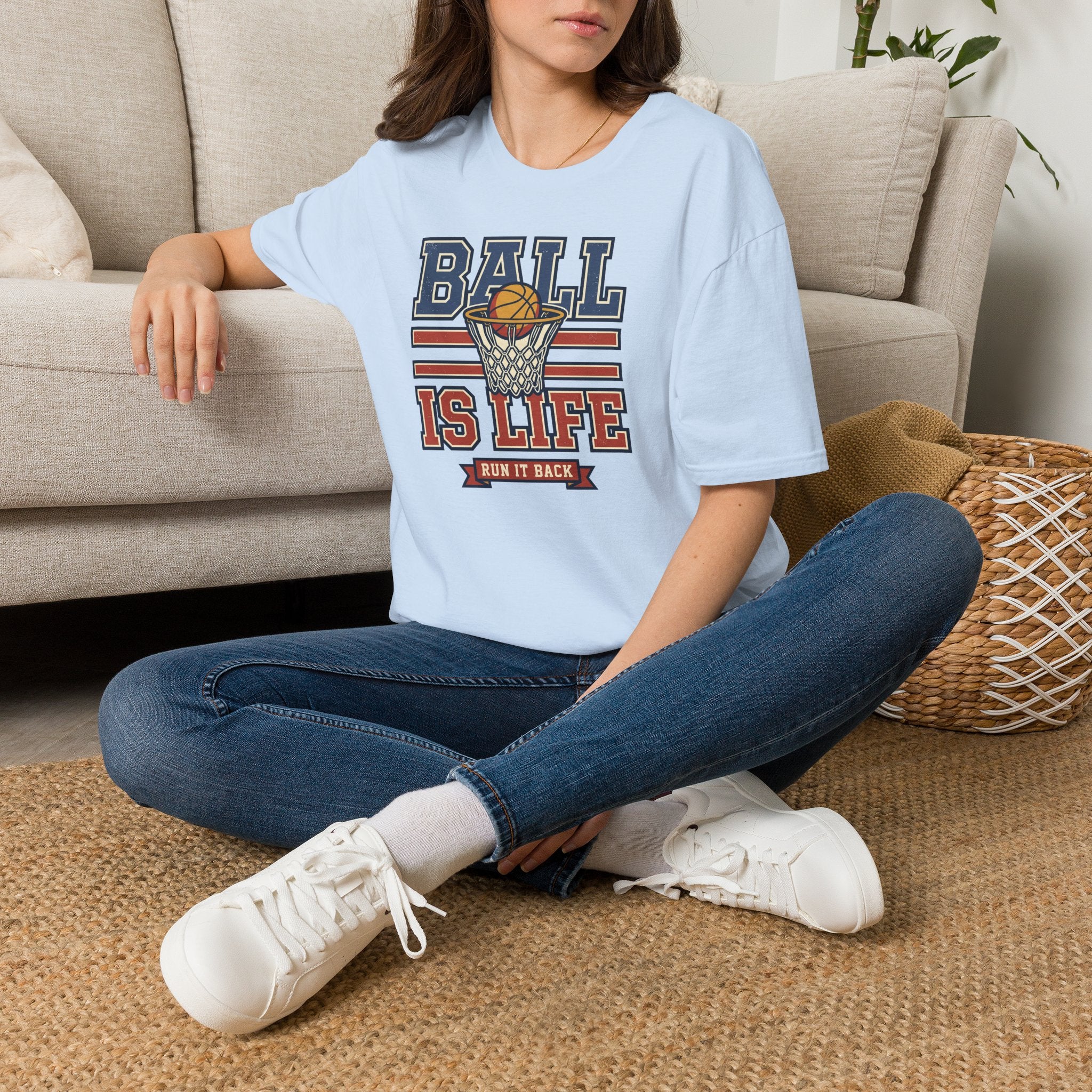 Light blue basketball T-shirt with 'BALL IS LIFE' hoop graphic, worn by model
