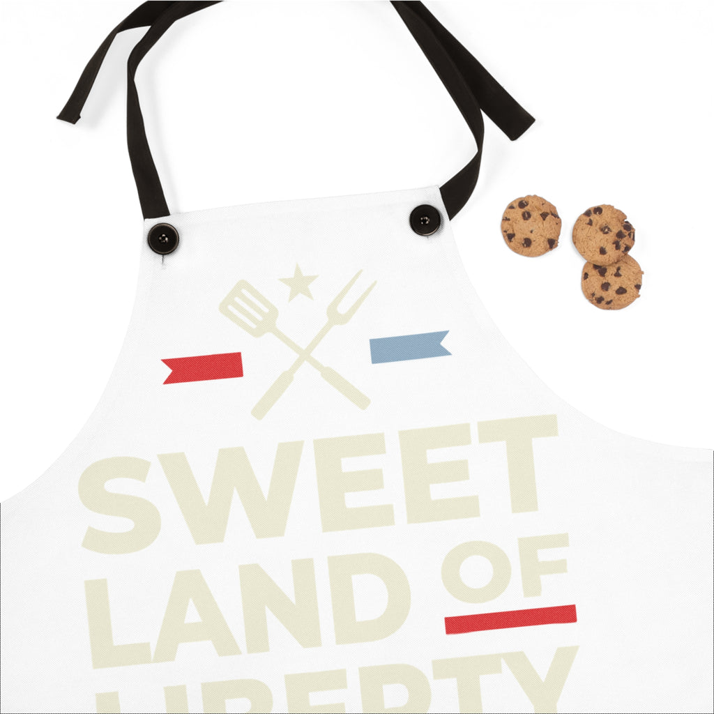 White apron front close-up with black buttons and patriotic cross tools logo