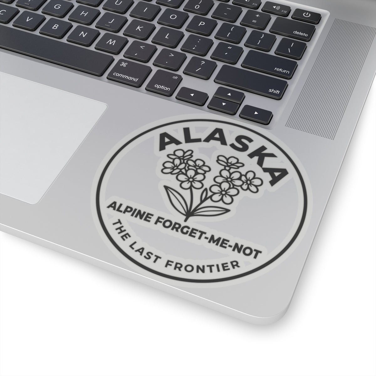 Alaska alpine forget-me-not vinyl sticker on laptop, circular wildflower badge