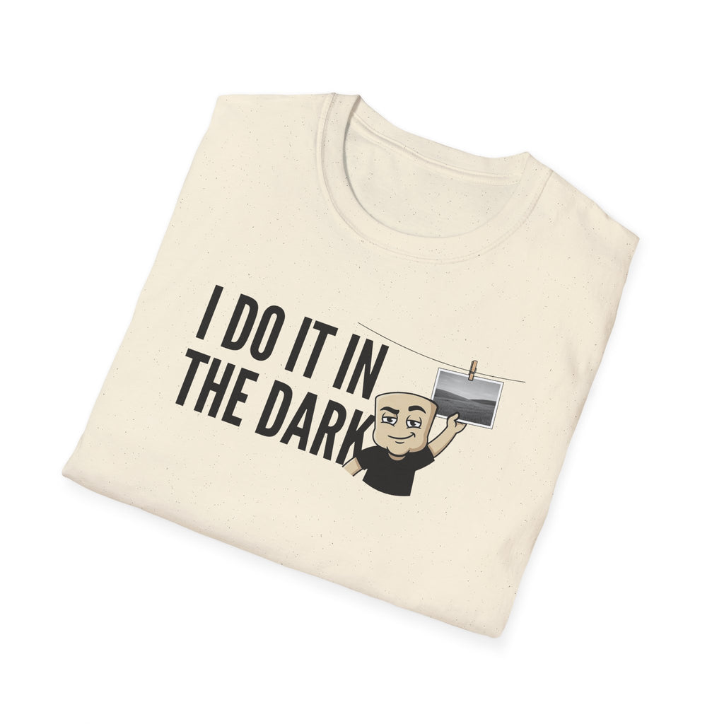 Natural/cream T-shirt with "I DO IT IN THE DARK" graphic and cartoon photographer
