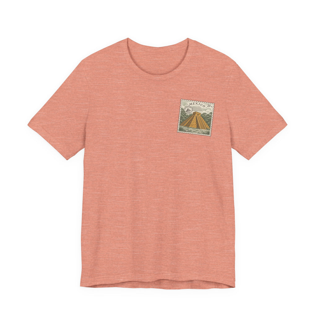 Coral t-shirt with small vintage-style Mexico stamp graphic on upper chest