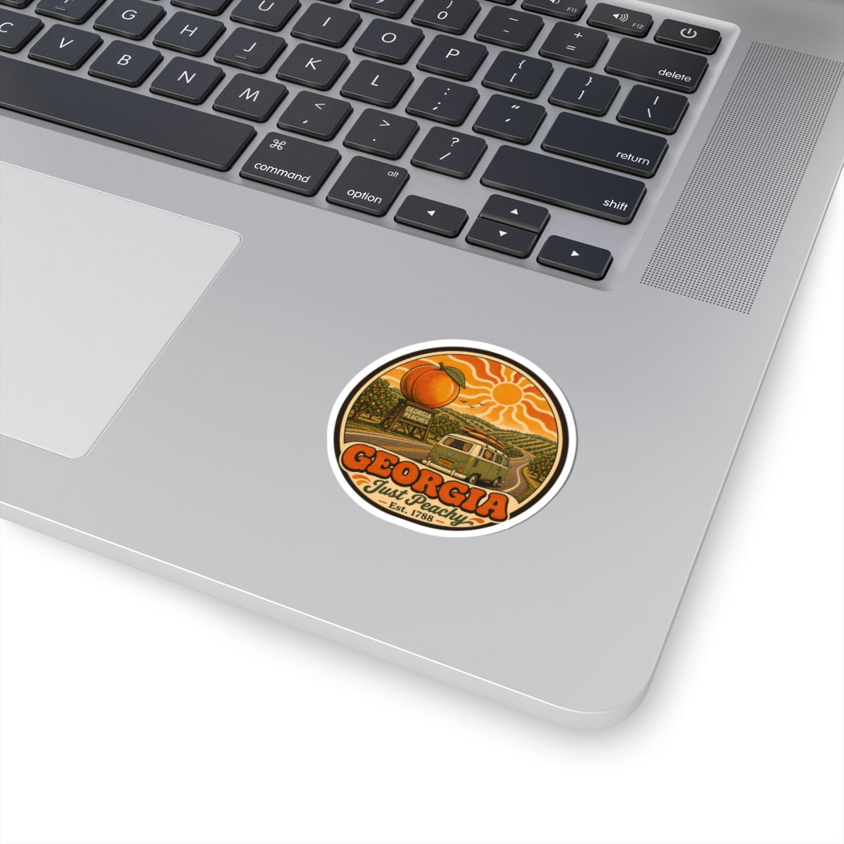 Round orange peach Georgia vinyl sticker on laptop