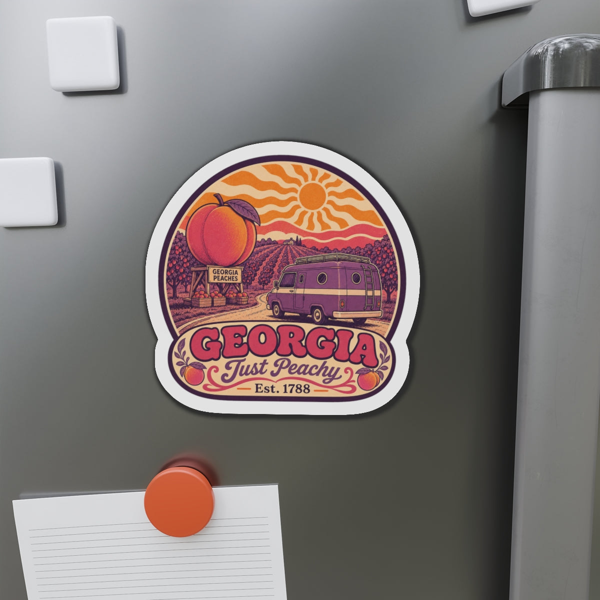 Die-cut Georgia van magnet on fridge, showing peach, sun, and “Just Peachy” banner