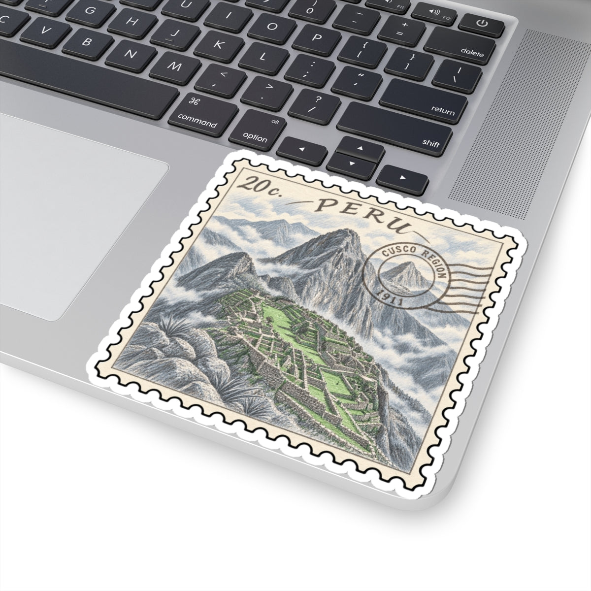 Machu Picchu stamp sticker on a laptop trackpad, with “Peru” text and terraces