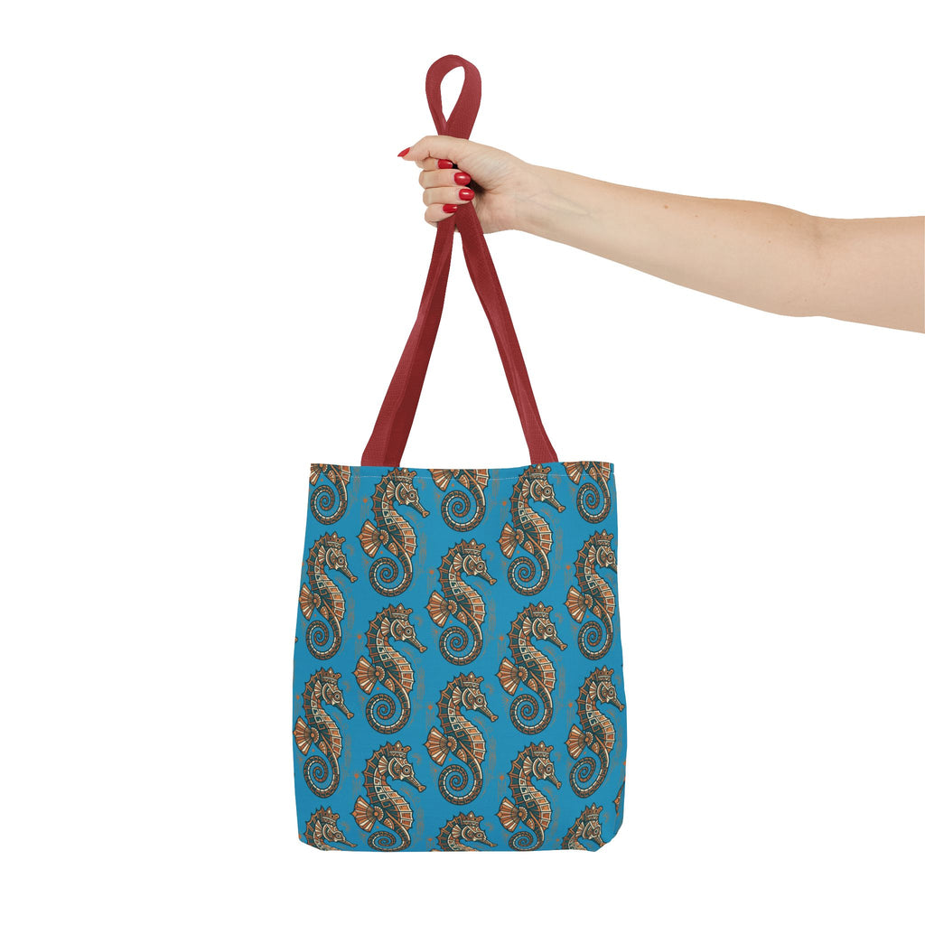 Tote bag held by red handles with blue seahorse pattern