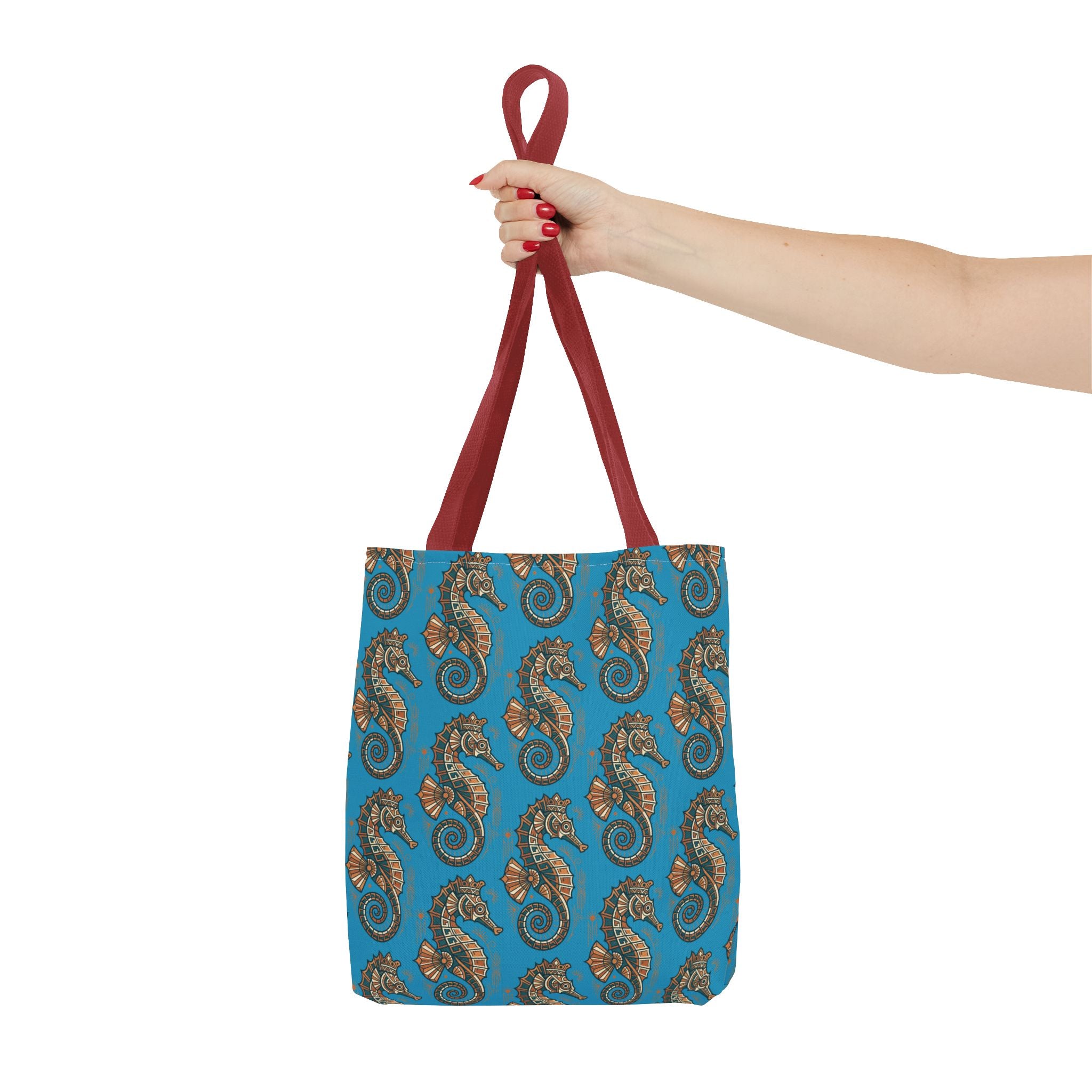 Tote bag held by red handles with blue seahorse pattern