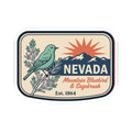 Nevada travel badge sticker with bluebird, sagebrush sprigs, mountain scene, and Est. 1864.