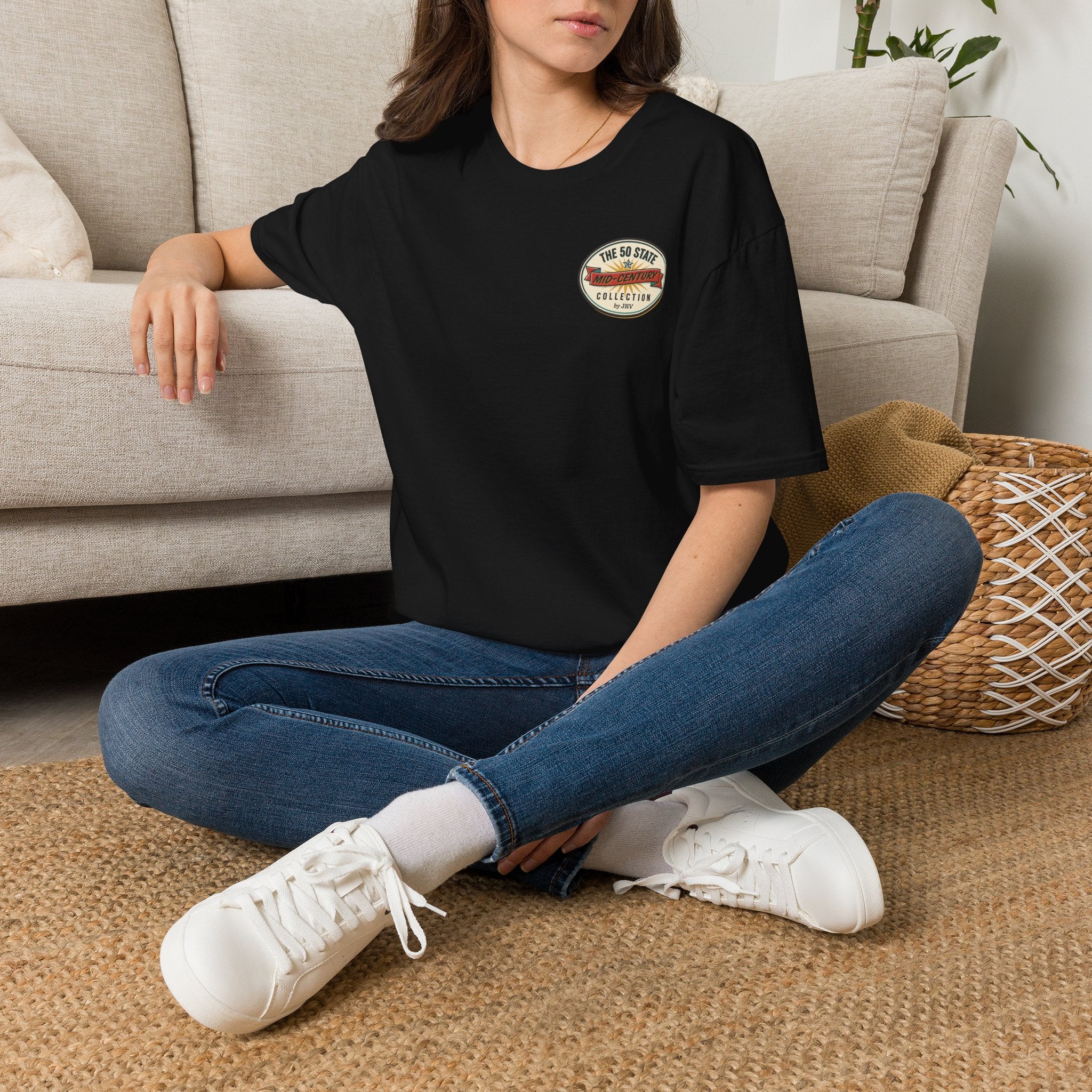 Black crew-neck t-shirt worn by model, featuring round “50 State” badge on left chest