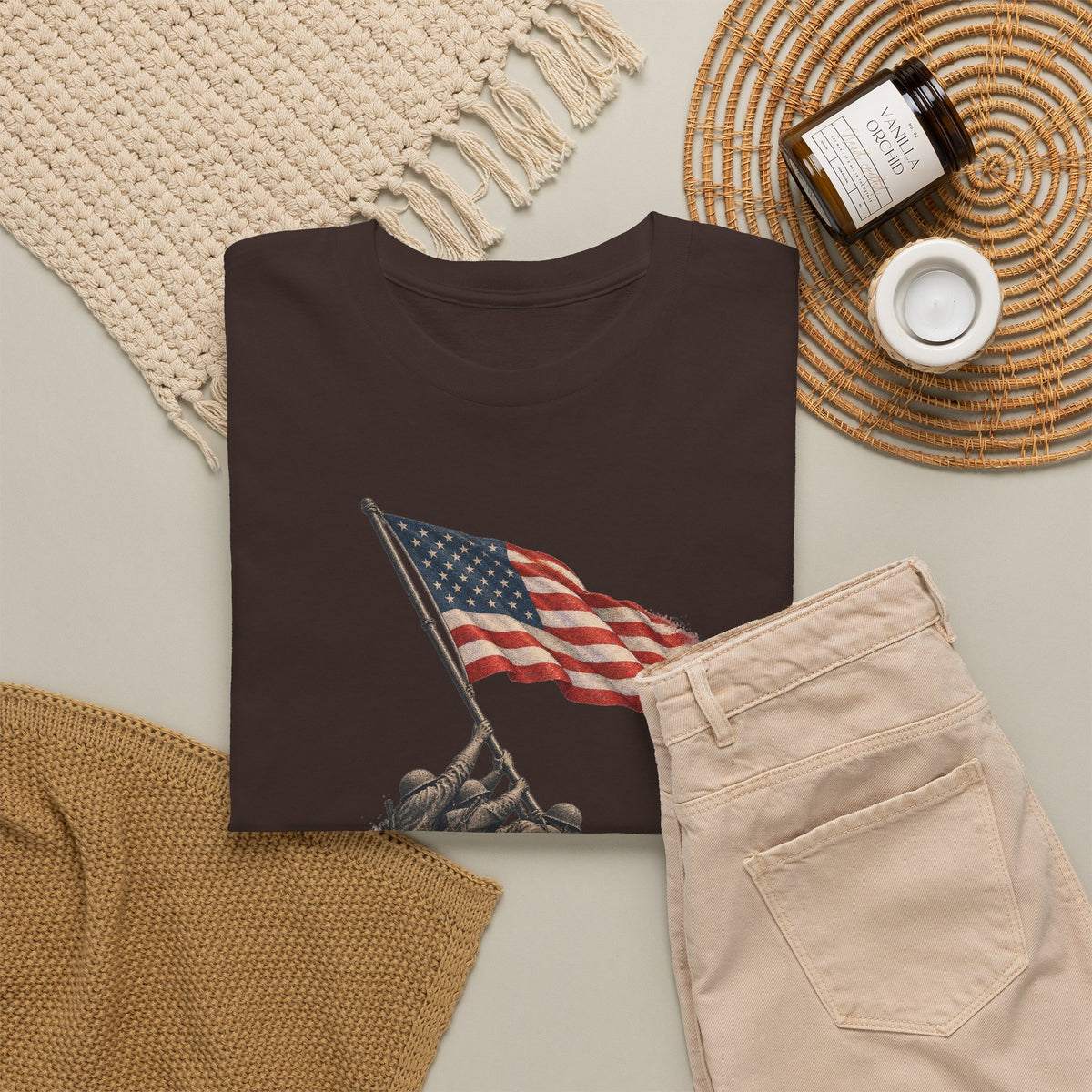 Dark brown crewneck T-shirt with flag-raising graphic, front