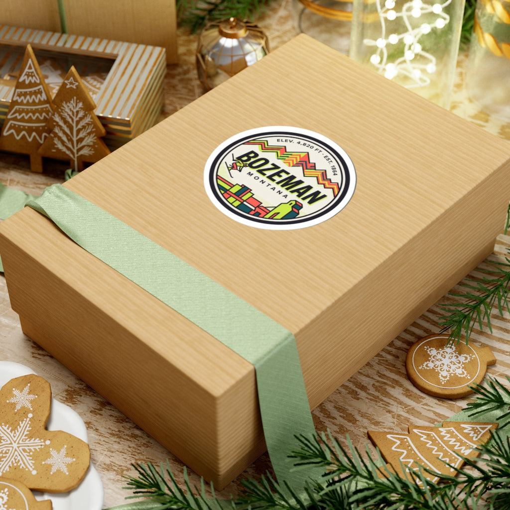 Round Bozeman Montana sticker on a wrapped gift, retro mountains and skyline logo