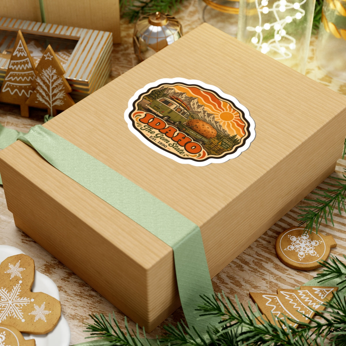 Idaho vintage roadtrip sticker on wooden gift box, showing green van, potato, mountains and sun.