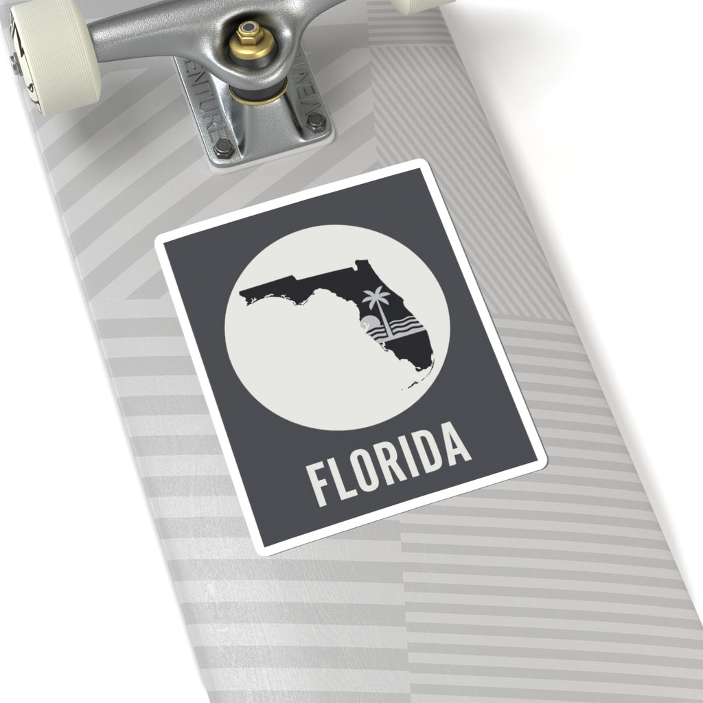 Florida silhouette sticker on notebook cover, circular palm wave graphic with FLORIDA text