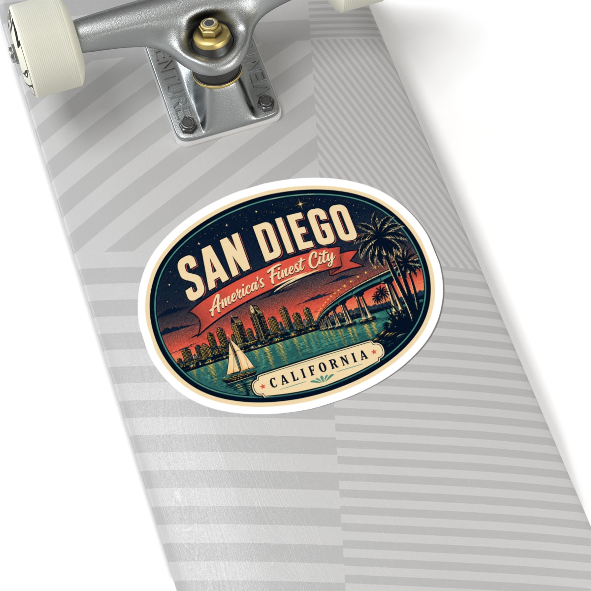 Round San Diego luggage tag sticker on a suitcase with striped background and California