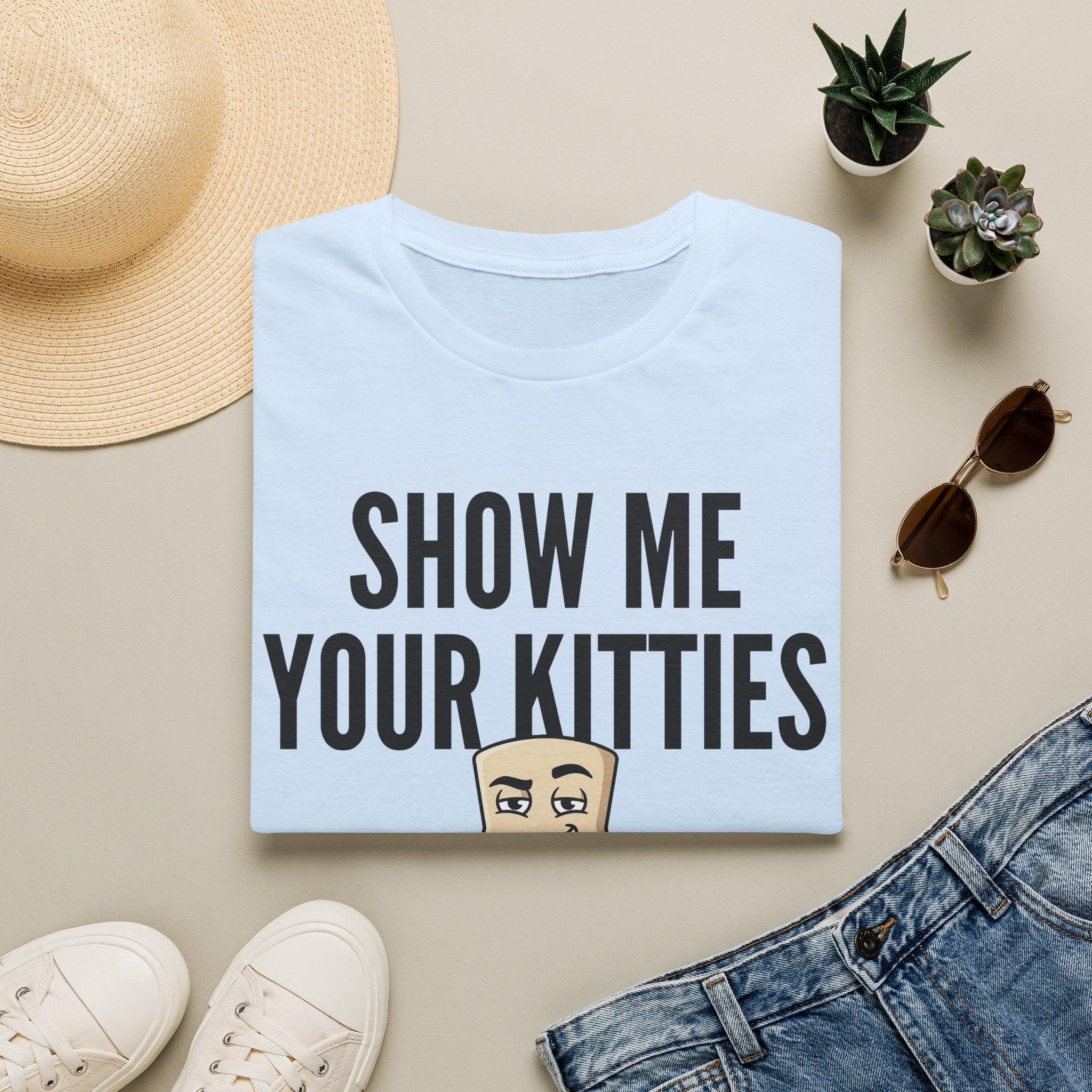 Light blue T-shirt with “SHOW ME YOUR KITTIES” cat graphic on the front.