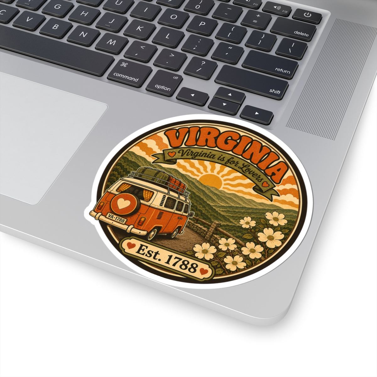 Circular decal featuring an orange vintage camper van and “Est. 1788” on a laptop