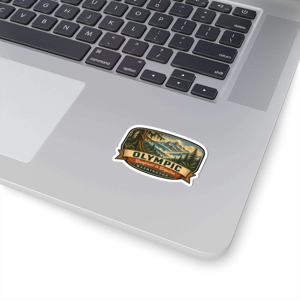 Travel sticker: die-cut Olympic park badge with mountain and forest graphic, white border