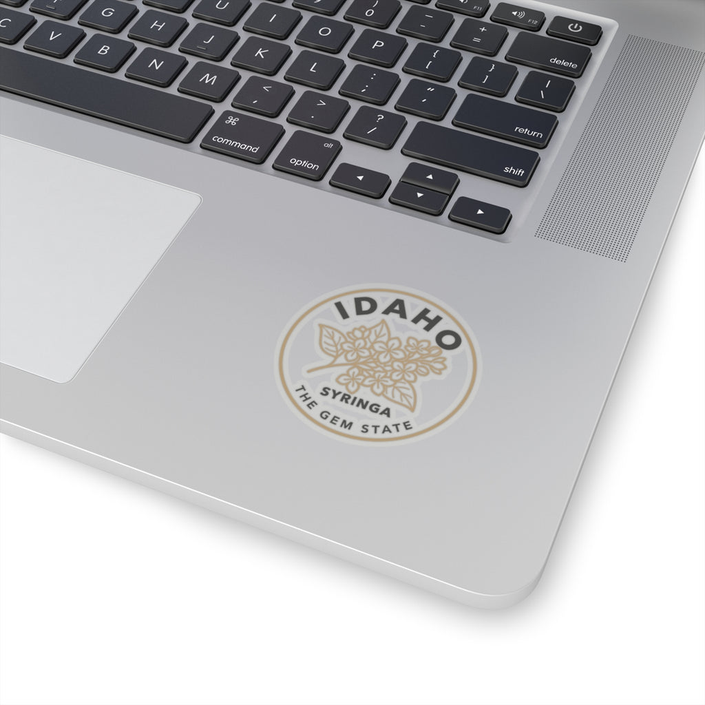 Transparent vinyl sticker on a laptop: circular Idaho syringa flower emblem